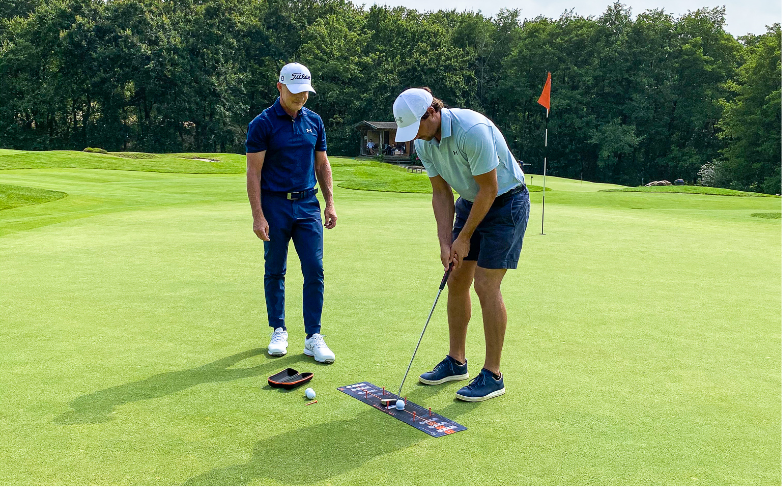 Cameron McCormick giving a lesson to a pro player helped by a Wellstroke